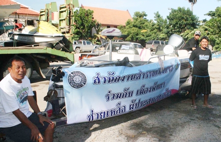 Local police load up boats and jet skis to bring supplies to flood victims in Pathum Thani.